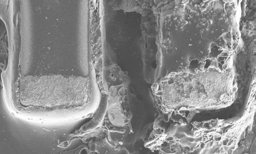 Defect analysis of a capacitor using light and scanning electron microscopy